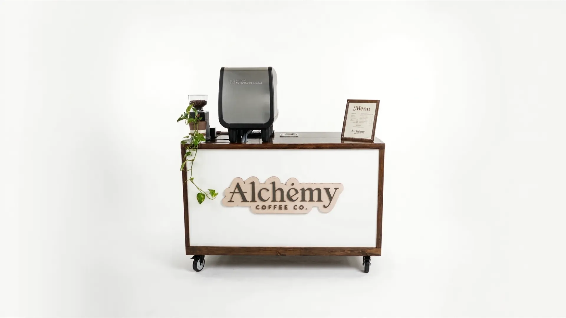 The Alchemy Coffee Co. cart — espresso machine, grinder and menu board on a wood-trimmed counter