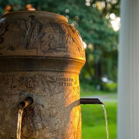 Water pouring from the carved stone Congress Spring fountain in Saratoga Springs